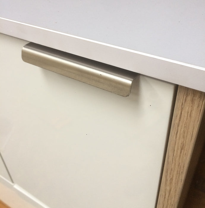 100mm stainless steel drawer latch attached to white cabinet