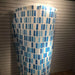 shower curtain holder mounted to wall with blue shower curtain attached